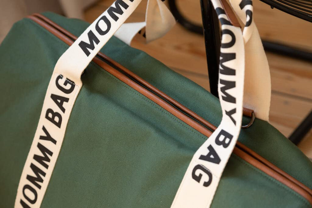 Childhome Signature Mommy Bag green luggage sleeve eases travel.