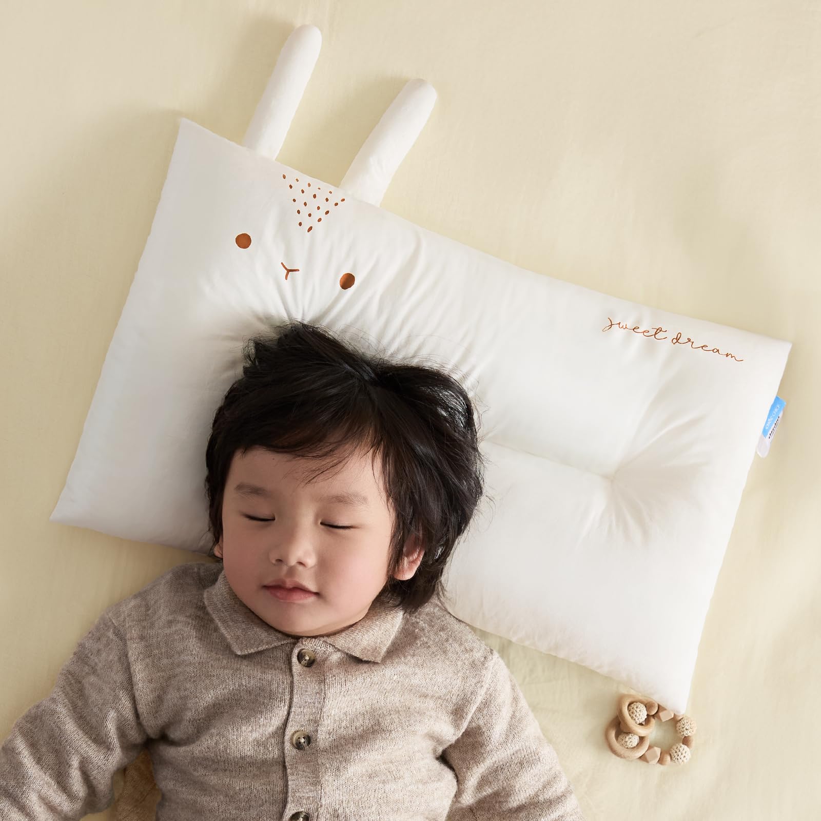 Choc chick pillow in crib setup demonstrates compatibility with sleepy-time routines.