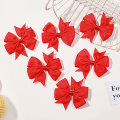 Choicbaby red pinwheel bow shown on a toddler, adding vibrant color to outfits.