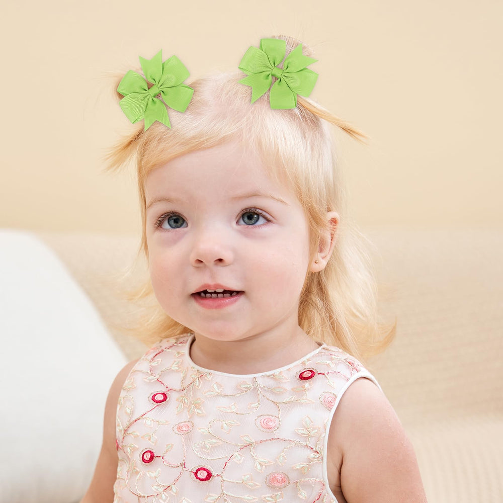 Choicbaby baby smiles with green bow, ideal for birthday outfits.