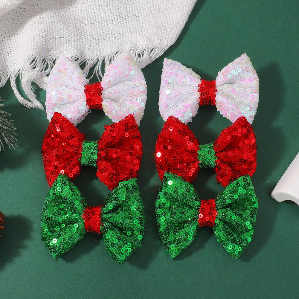 Choicbaby child wearing Christmas bows for festive photos and events.
