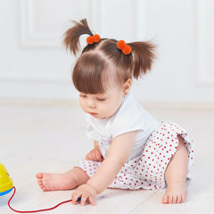 ChoicBaby close-up of 1.5-inch pom-ball hair tie's soft elasticity.