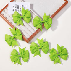 Choicbaby green grosgrain bow on head, comfortable all-day wear.