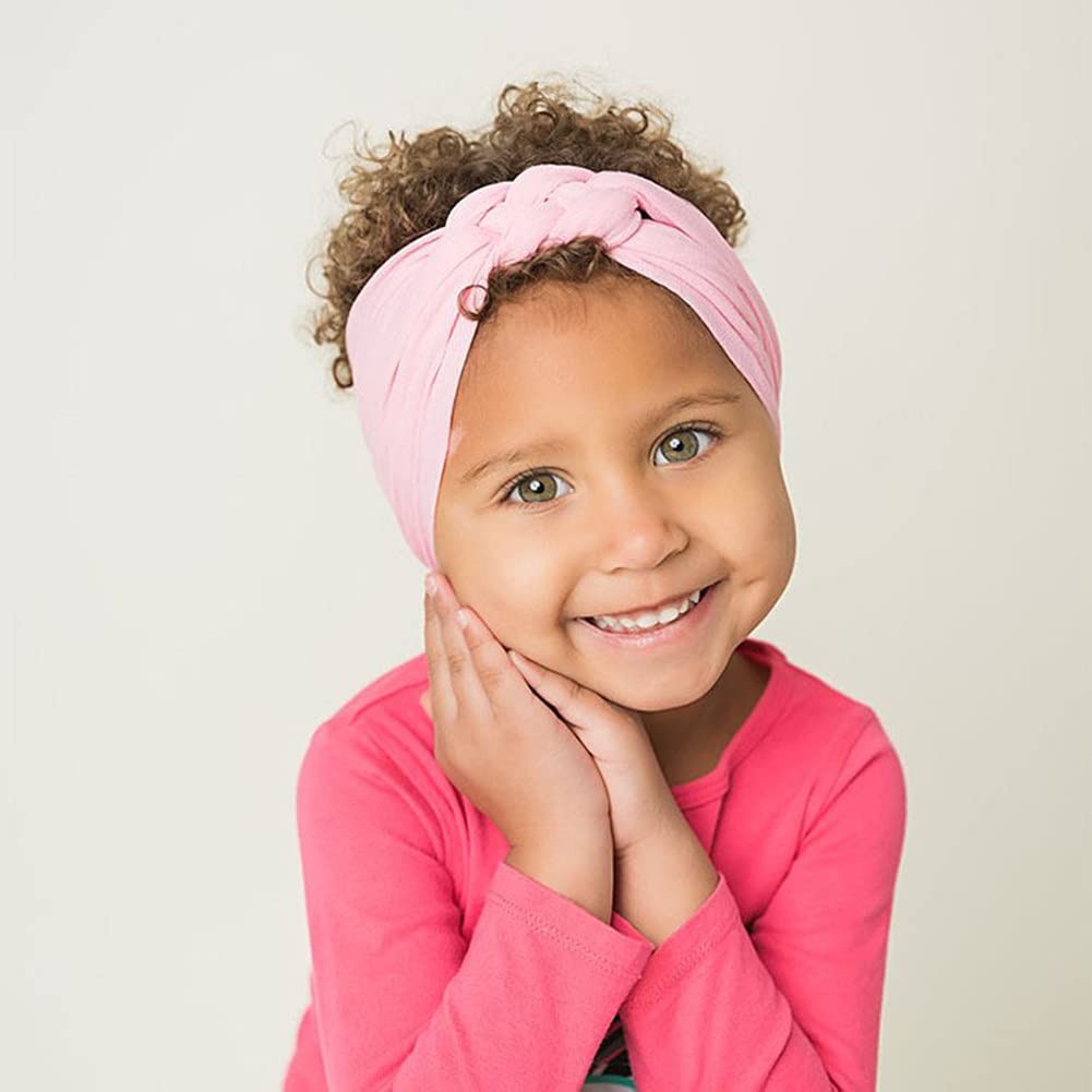 Cinaci coral pink knotted headband adds bright color with comfy, stretchable fit.