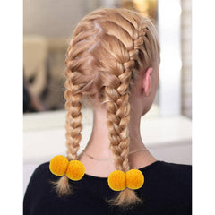 Cinaci baby girls hair accessory featuring soft pompoms for cute charm.