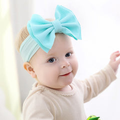Cinaci big bow detail closeup highlights soft materials for tender skin.