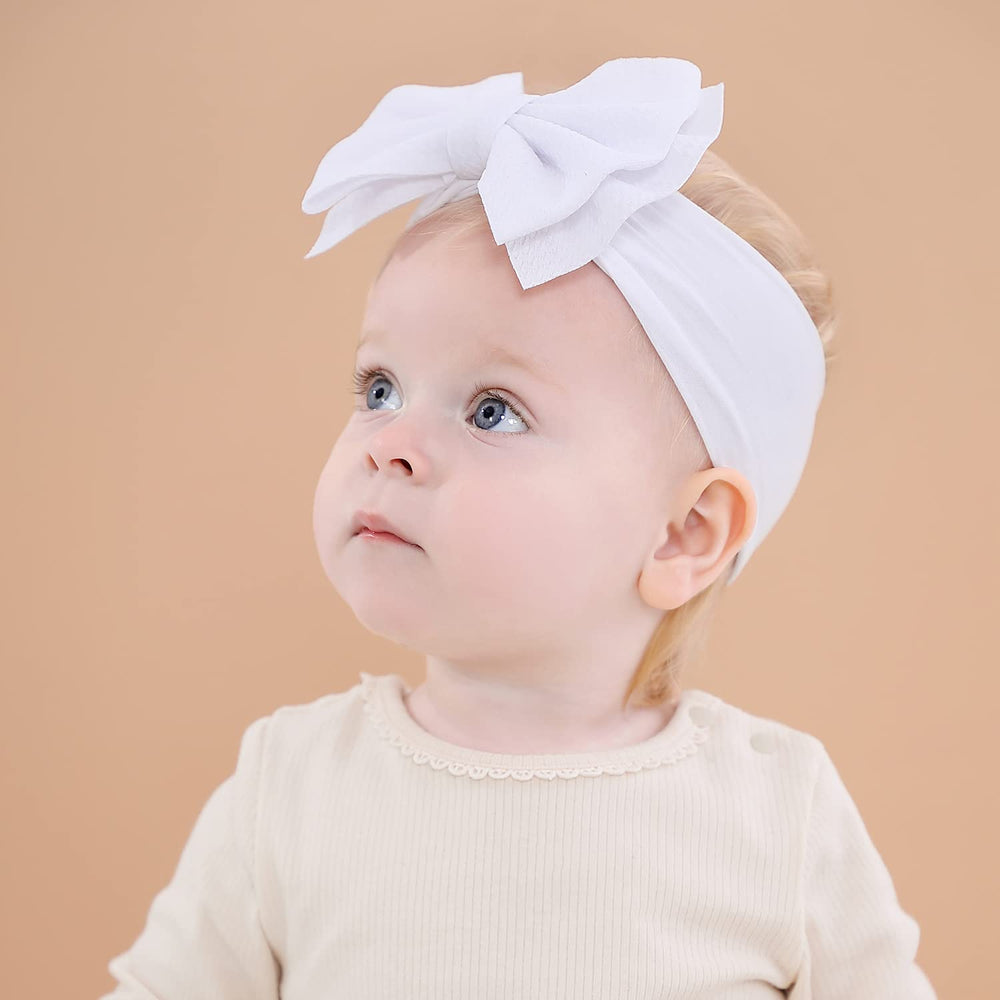 Cinaci headbands worn on infant demonstrate gentle stretch and secure fit.