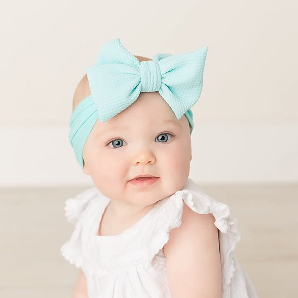 Cinaci large bows on durable dacron-spandex offer chic, lasting style.