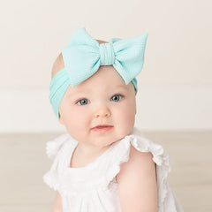 Cinaci large bows on durable dacron-spandex offer chic, lasting style.