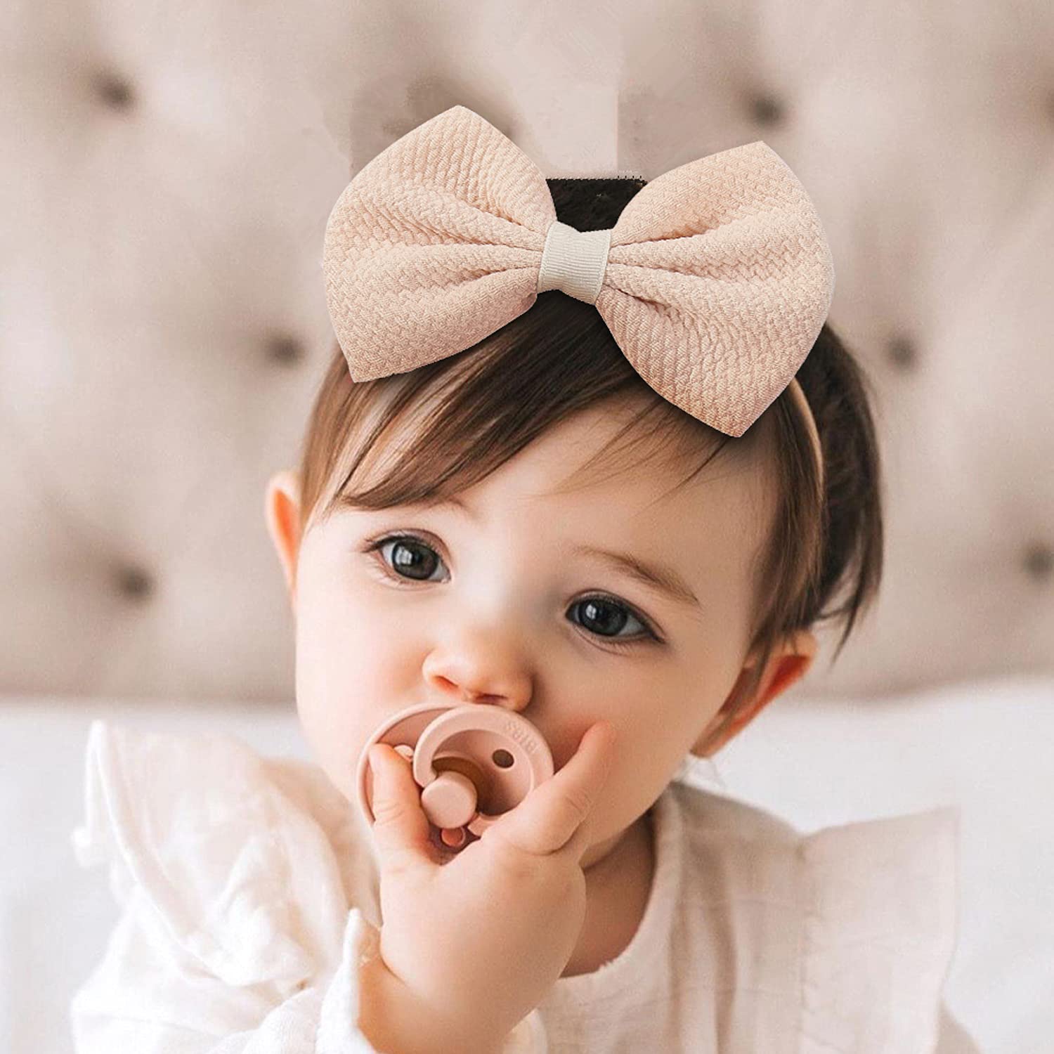 Cinaci soft nylon band with bow detail provides tender-skin comfort.