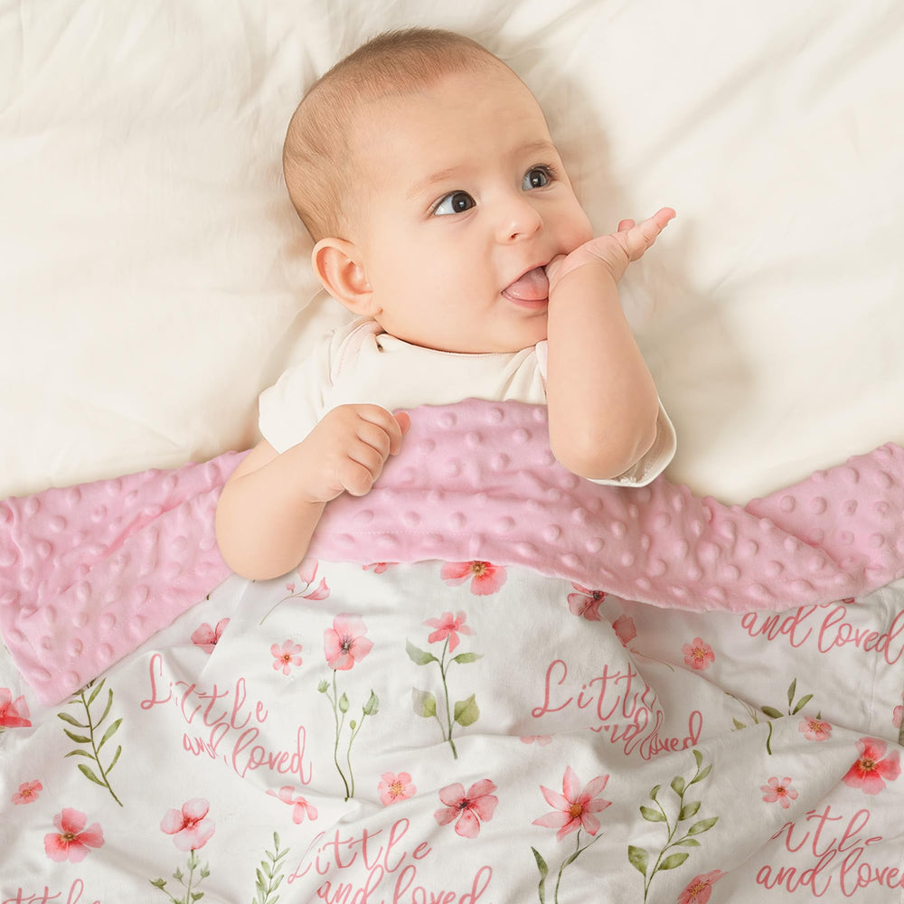 Civarua Kids pink baby blanket with checkerboard design draped over a crib.