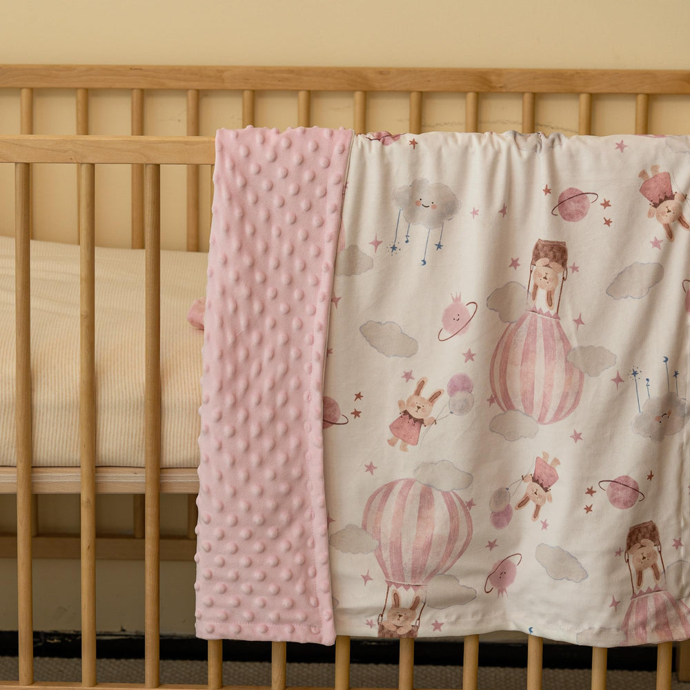 CIVARUA KIDS Minky blanket shown swaddling a sleeping baby for cozy warmth