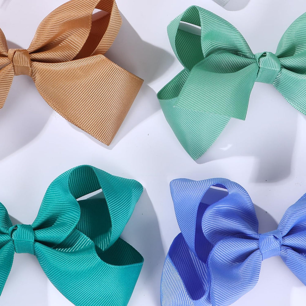 Clipband hair bows attached to clips showcasing secure, easy-to-use design for toddlers.