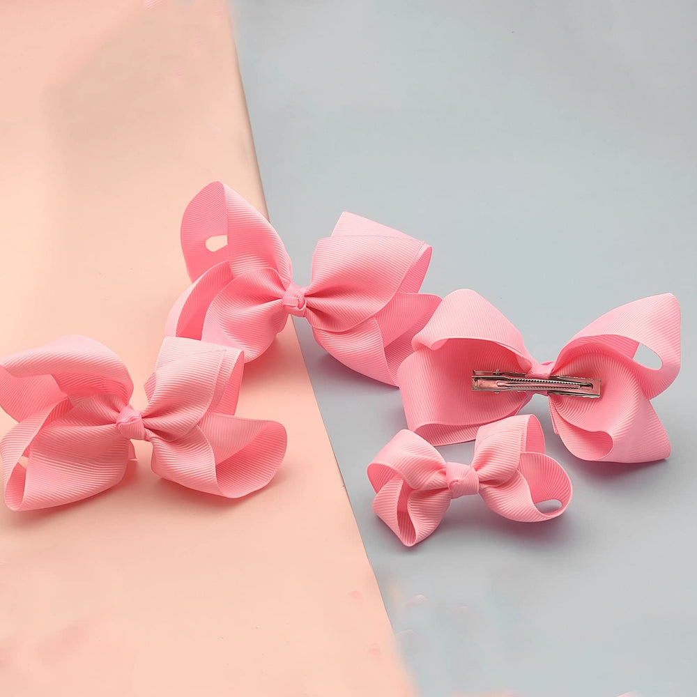 Clipband light pink bows alligator clip closeup showing secure grip.