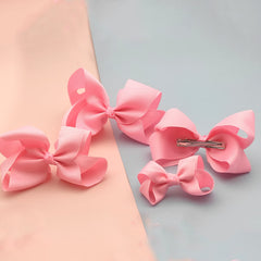 Clipband light pink bows alligator clip closeup showing secure grip.