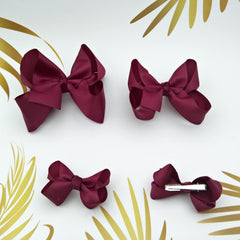 Clipband maroon bows with sturdy alligator clips for quick, secure hair styling.