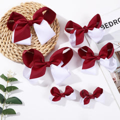Clipband maroon-white bows alligator clip closeup shows sturdy grip for secure wear