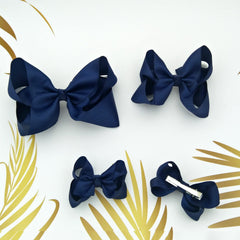 Clipband Navy Bows on an alligator clip shows secure grip.