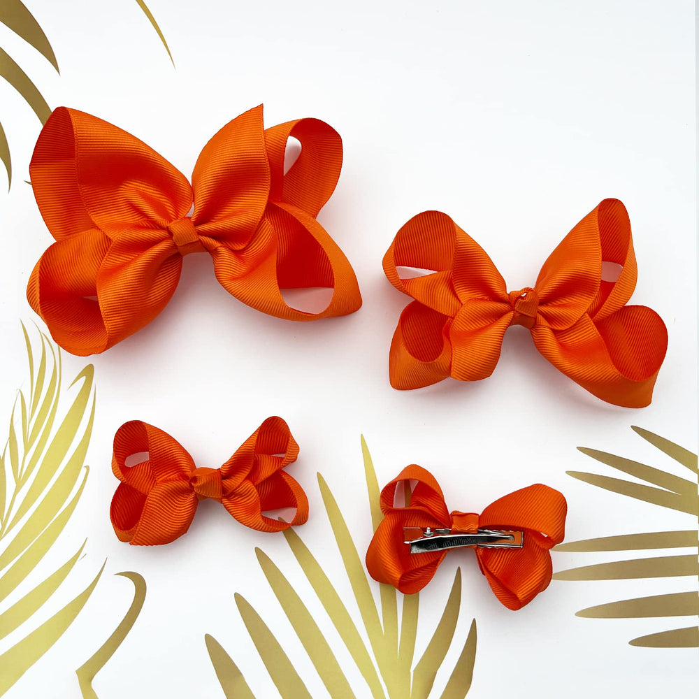 Clipband Orange Bows on ponytail demonstrates easy, comfortable, all-day hold.