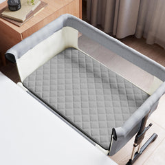 Coldwind bassinet pad cover waterproof TPU layer shields mattress from spills.