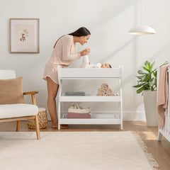 Comfy Cubs timeless white finish changing table blends with nursery decor while organizing essentials.