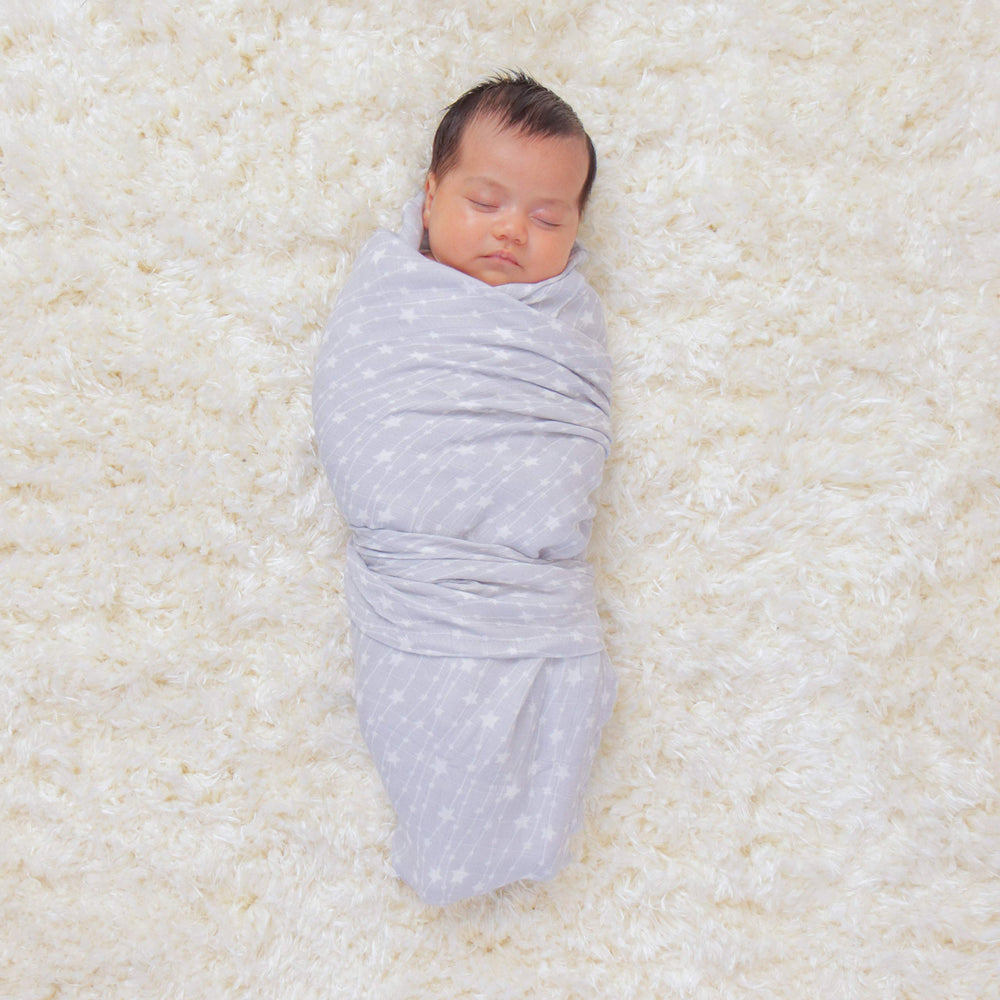 Comfy Cubs muslin swaddle blankets open layout showing generous 47x47 coverage for versatile use.