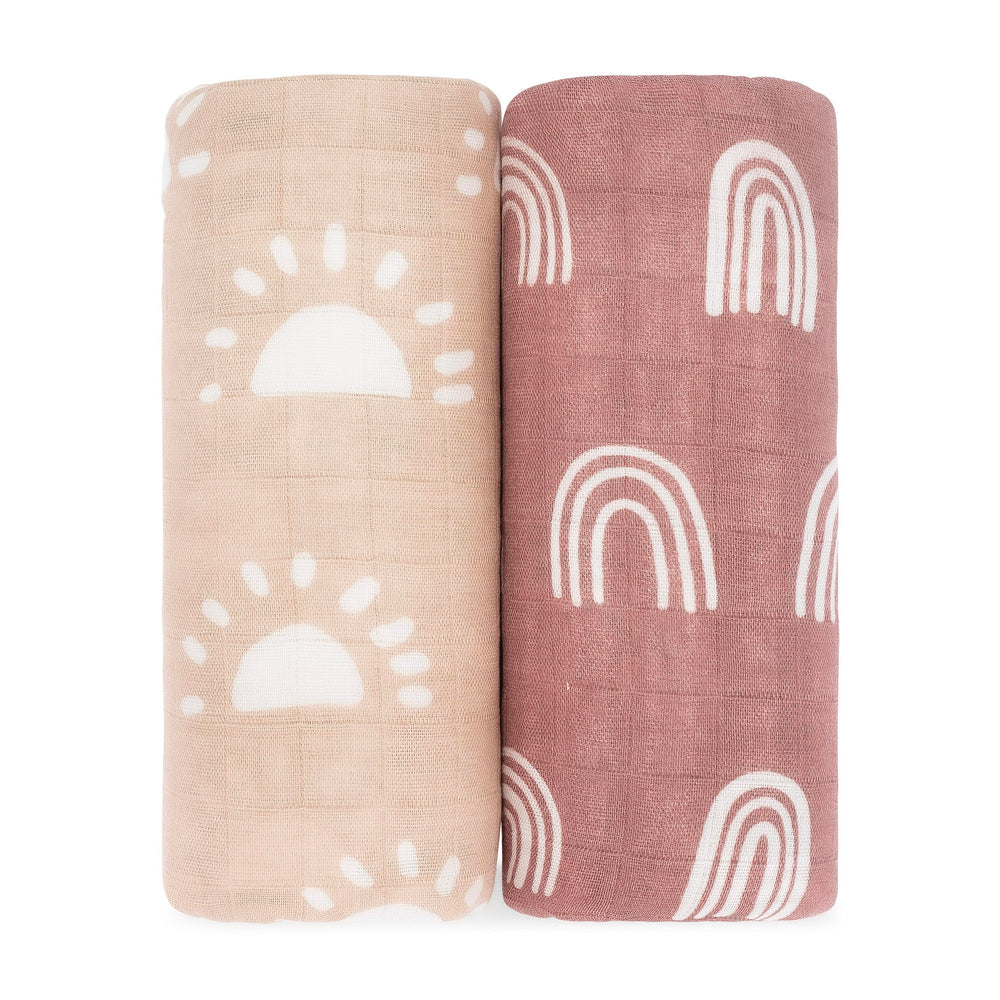 Comfy Cubs muslin swaddle sun pattern drapes softly over baby during cozy daytime naps.