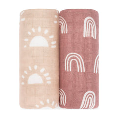 Comfy Cubs muslin swaddle sun pattern drapes softly over baby during cozy daytime naps.
