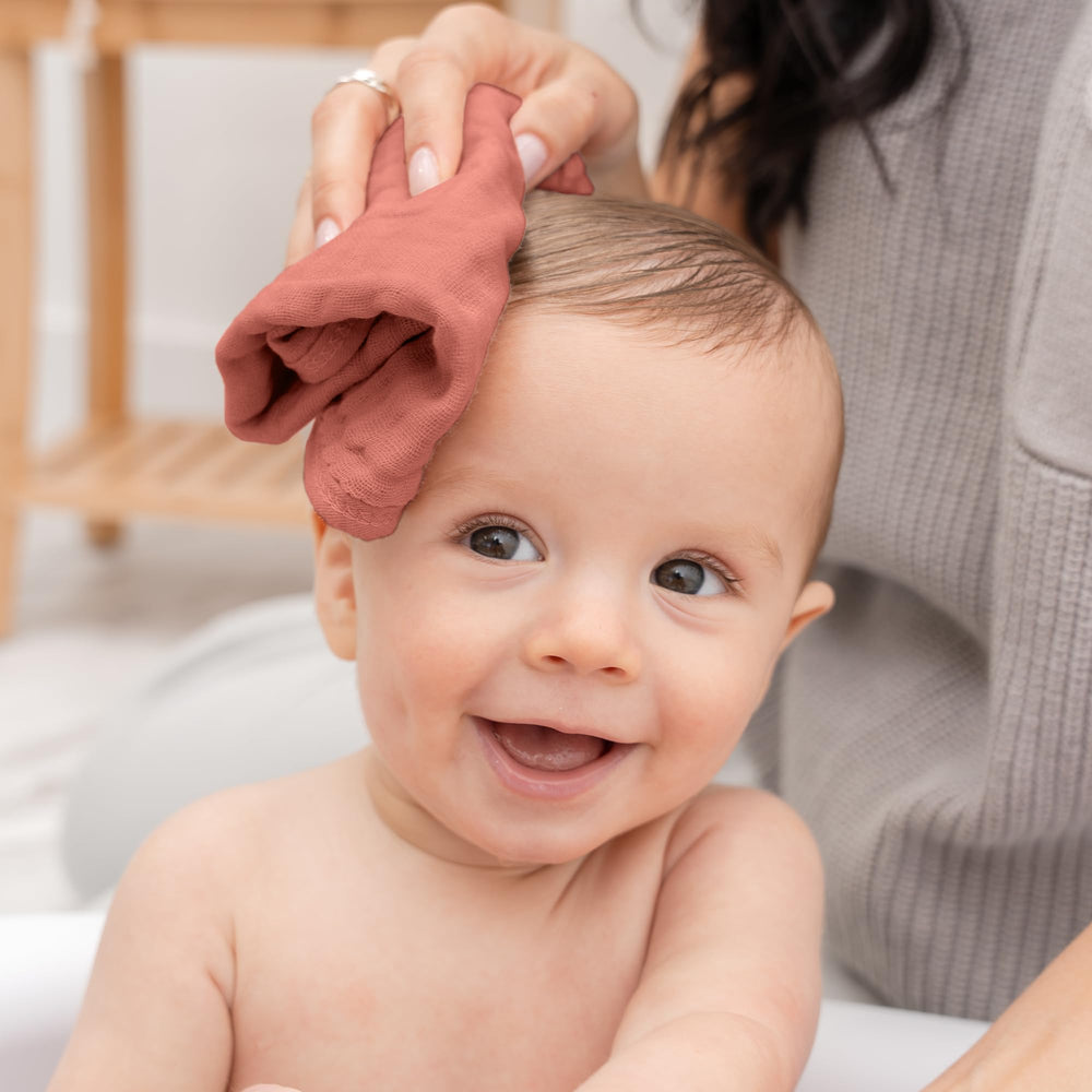 Comfy Cubs muslin washcloth close-up shows its suitability for bath time spills and messes.