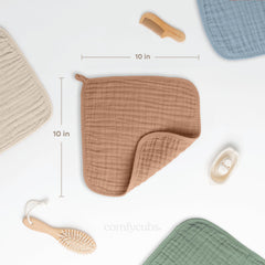Comfy Cubs muslin washcloths six-layer fabric demonstrates quick water absorption during mess cleanup.