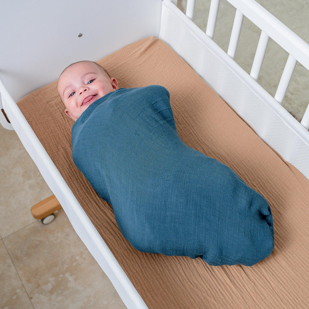 Comfy Cubs Neptune muslin swaddle blanket ideal for tummy time and easy transitions.