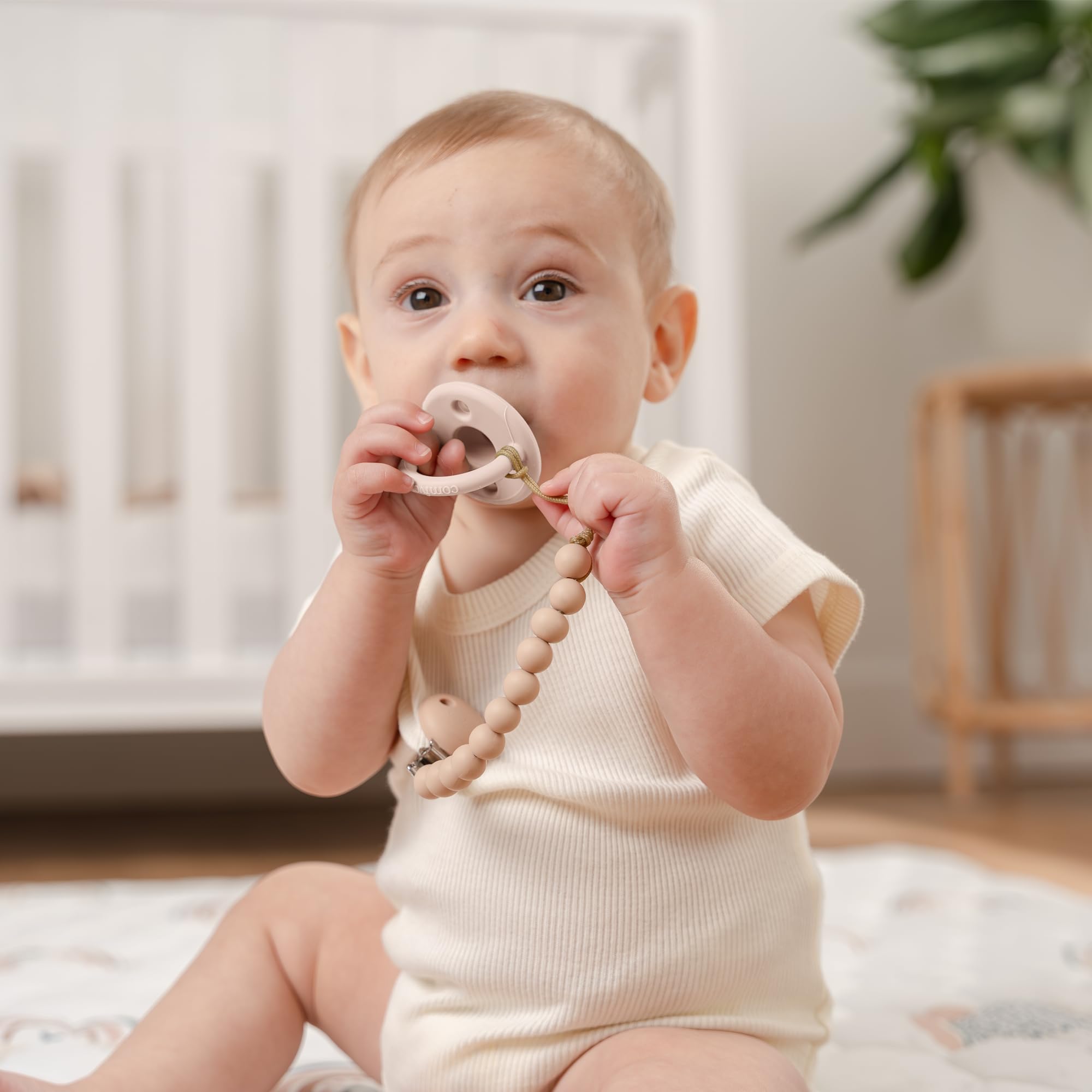 Comfy Cubs light beige pacifier clip with CPSIA-certified construction for durable daily use