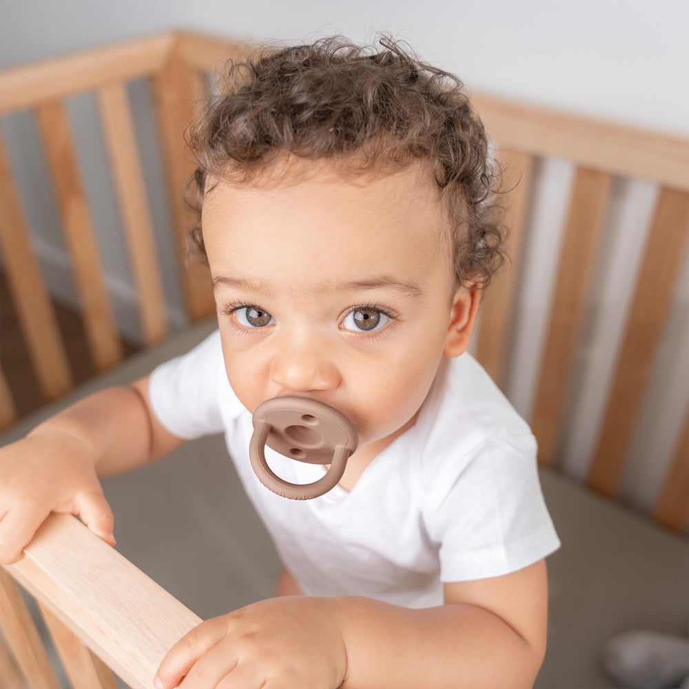 Comfy Cubs pacifier close-up shows soft breast-like nipple shape for soothing feeds.