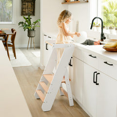 Comfy Cubs step stool folded flat for compact storage behind cabinet