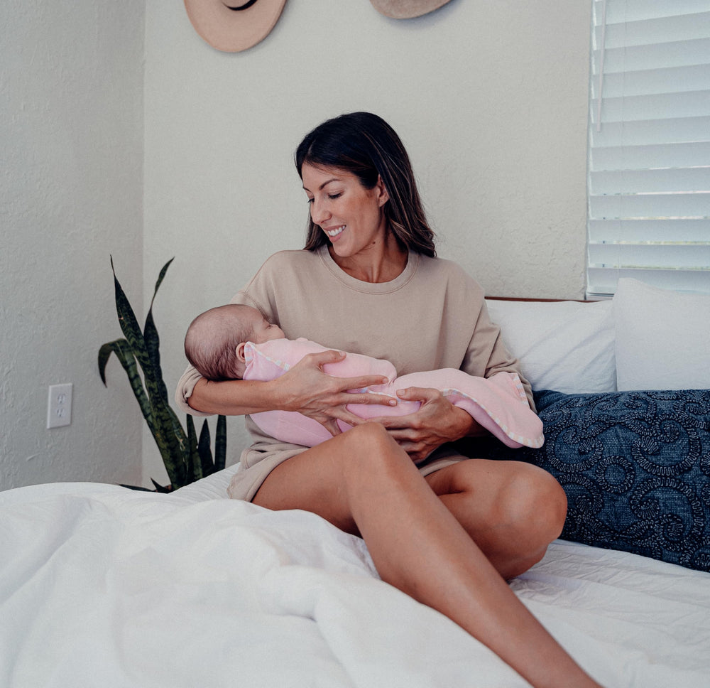 Comfy Cubs swaddle blanket pink zipper close demonstrates quick secure swaddling.