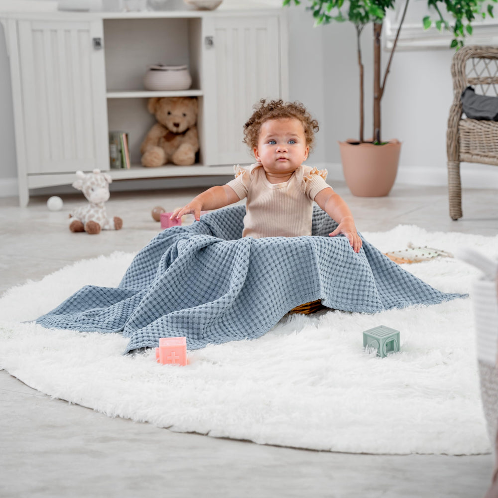 Comfy Cubs waffle blanket folded for bed or couch demonstrates versatile bed, couch, or travel cover.