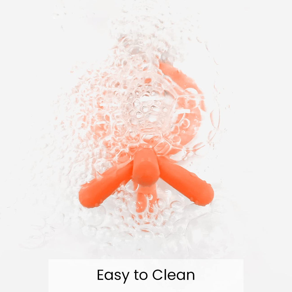 Comotomo teether orange material silicone emphasizing durable, safe chewing material.
