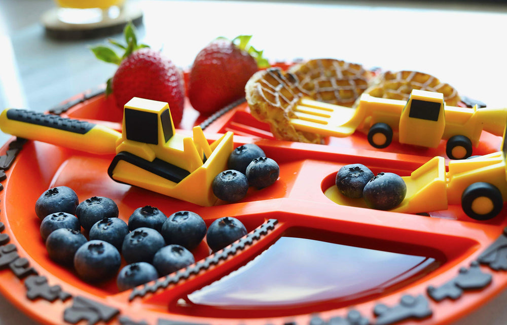 Small-hands-friendly utensils and divided plate by Constructive Eating promote self-feeding practice.