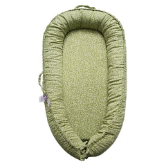 CooCooBaby infant lounger in Green Wonder cover offers cradle-like support during play.