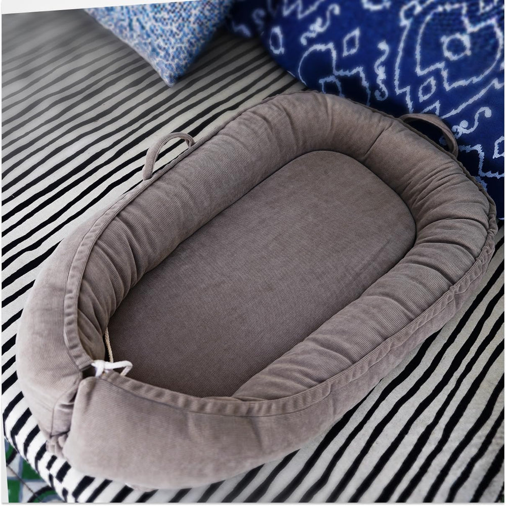 CooCooBaby infant lounger side view highlights growth-adjustable ends for longer use.