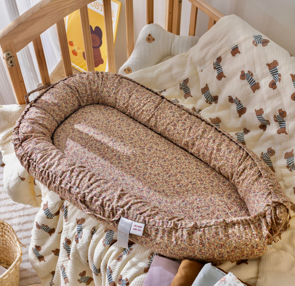 CooCooBaby infant lounger close-up shows breathable cotton texture for comfy naps.