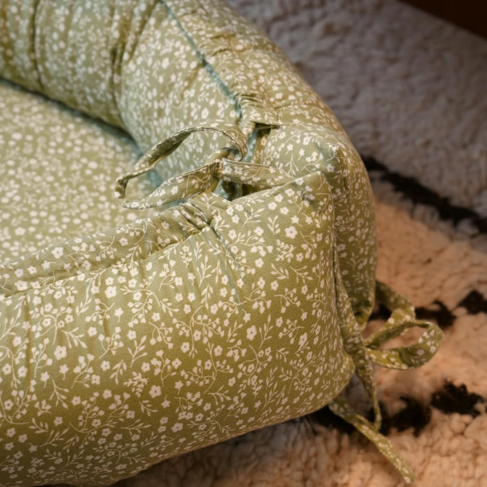 CooCooBaby nest cover double-sided design adapts as babies grow.