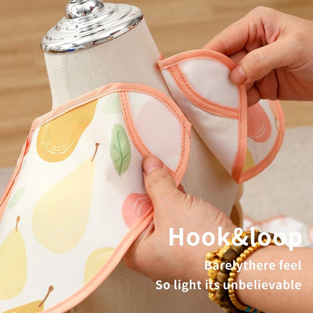 CoolaPeach bib with large pocket close-up demonstrates crumb catching and snack storage