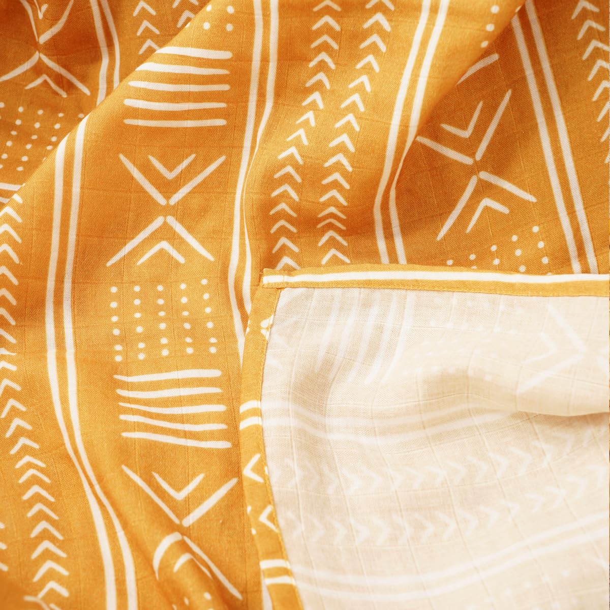 CoolaPeach muslin swaddle blanket diaper pad use, handy multi-use for changes and spills.