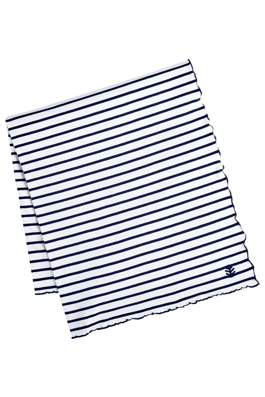 Coolibar Sun Blanket laid on park grass, ideal for picnics with UPF 50+ sun protection.