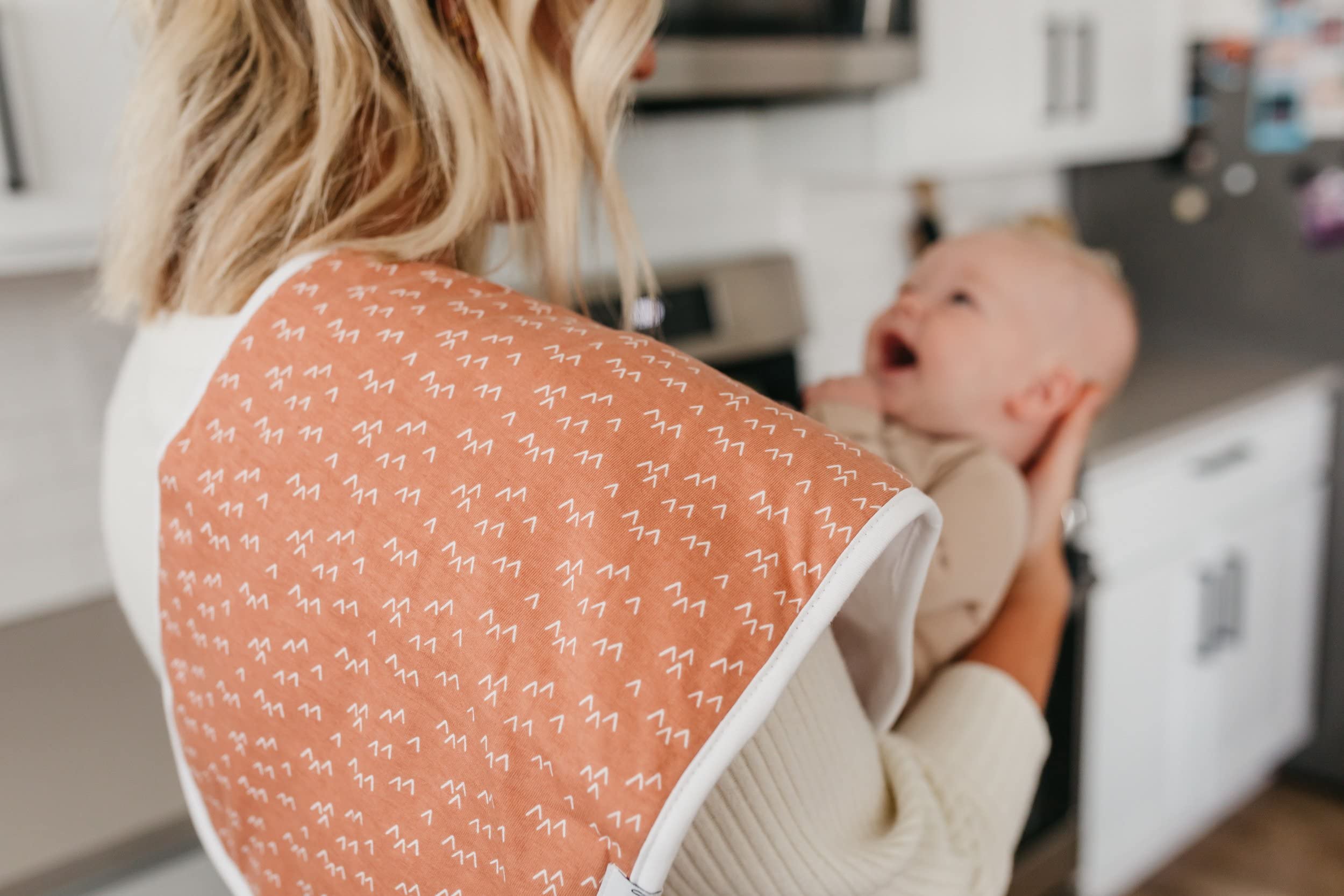 Copper Pearl Atwood burp cloths on shoulder during feeding sessions