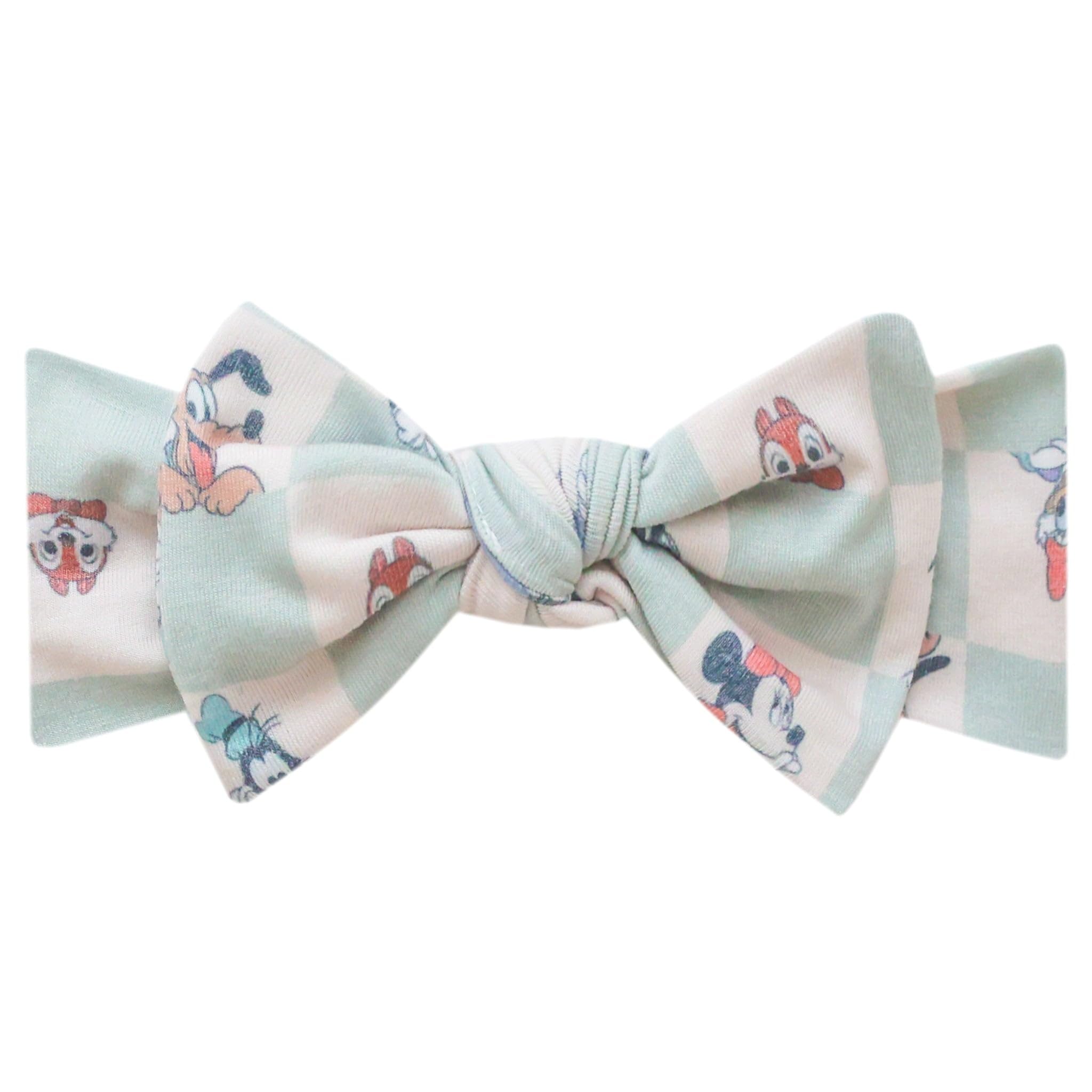 Copper Pearl baby headband with Mickey Mouse bow close-up showing gentle stretch for newborns