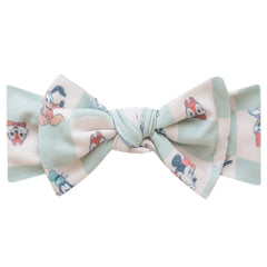 Copper Pearl baby headband with Mickey Mouse bow close-up showing gentle stretch for newborns
