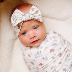 Copper Pearl Minnie Mouse Bowquet headband flat lay highlights trendy print to elevate baby outfits.