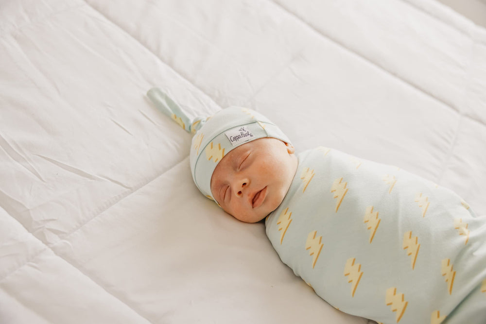 Copper Pearl baby swaddle blanket chic print highlights family-friendly fashion.